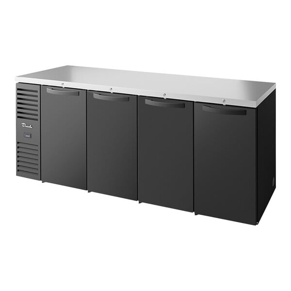 A black rectangular True back bar refrigerator with solid doors.