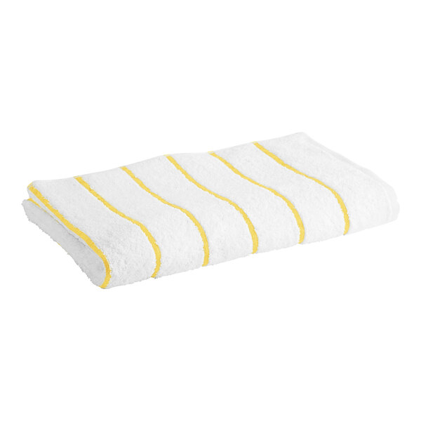 A Garnier-Thiebaut white pool towel with yellow stripes.