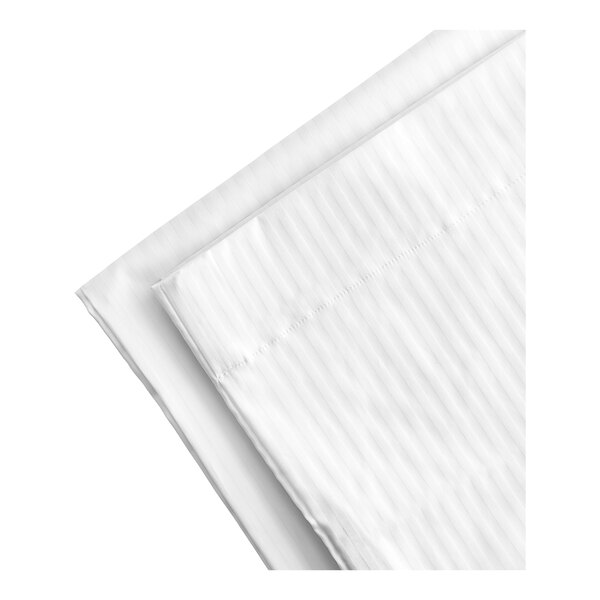A close-up of folded white Garnier-Thiebaut pillowcases.