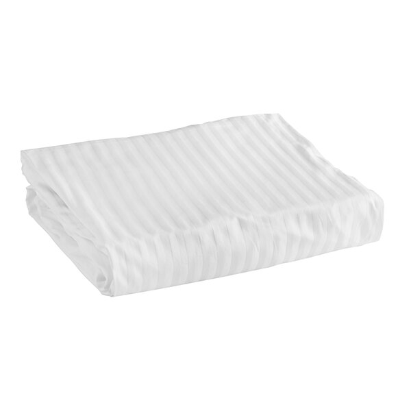 A folded white Garnier-Thiebaut Riviera fitted sheet with tone-on-tone stripes.