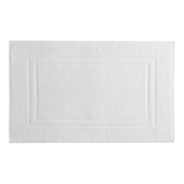 A white rectangular bath mat with a few lines on the border.