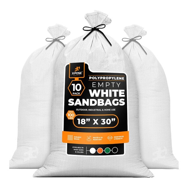 A group of white Xpose Safety woven polypropylene sandbags with black and orange labels.