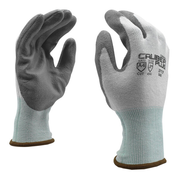 A pair of Cordova Caliber Plus gloves with white and gray palms.