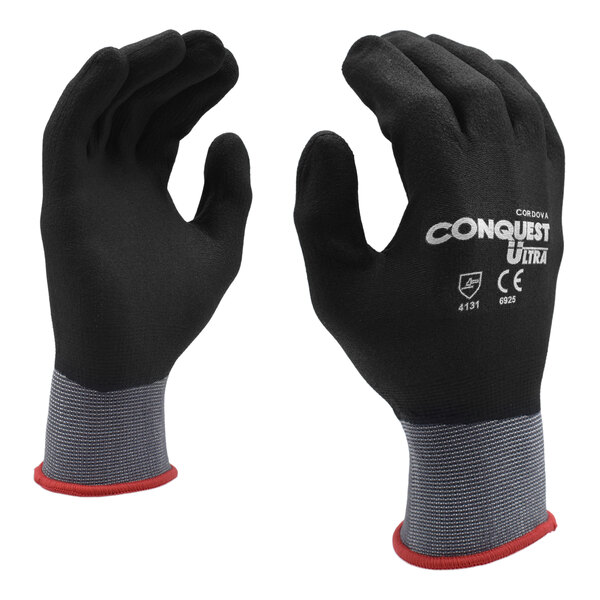 Two black gloves with red trim.