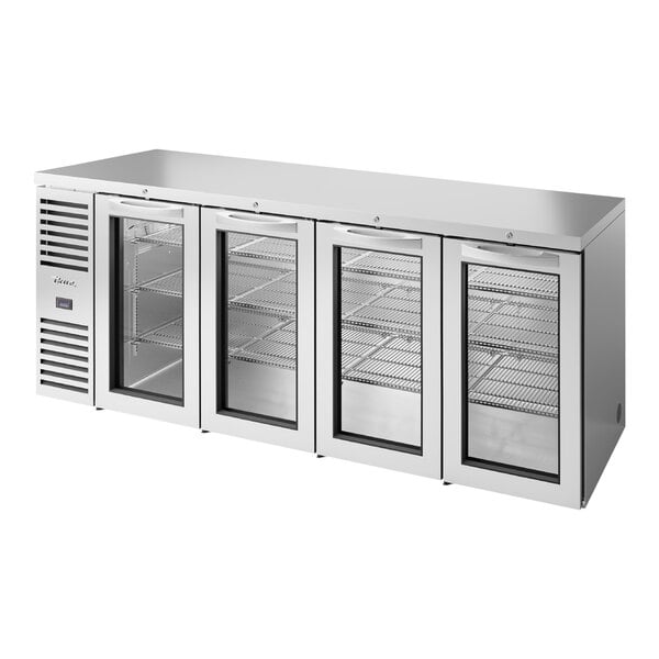 A True stainless steel back bar refrigerator with three glass doors.