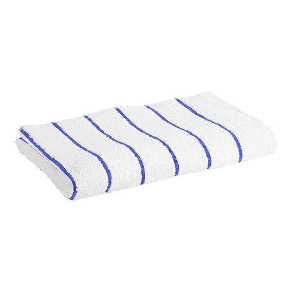 A white Garnier-Thiebaut pool towel with blue stripes.