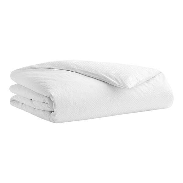 A stack of white Garnier-Thiebaut Normandie duvet covers.