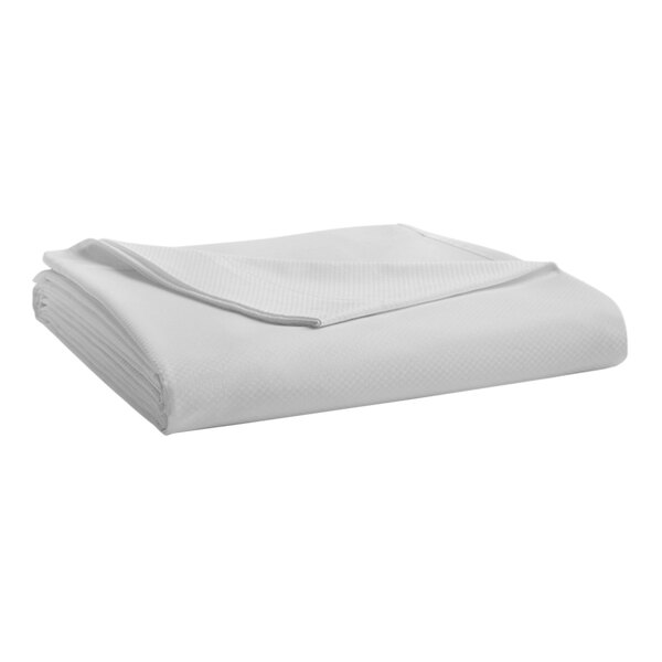 A folded Garnier-Thiebaut white king size flat sheet.