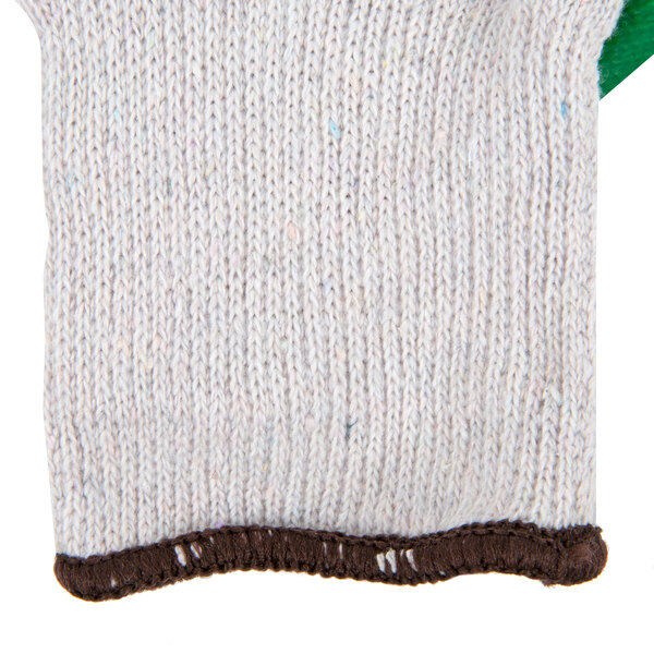 A white knitted work glove with green latex coating on the palm.
