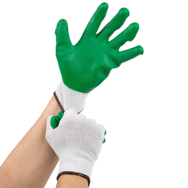 A pair of hands putting on small Cordova work gloves with green latex palms.