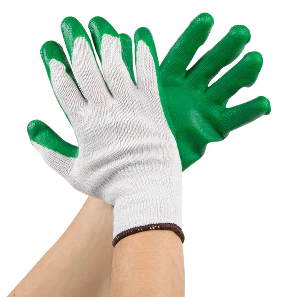 A pair of hands wearing green and white Cordova work gloves.