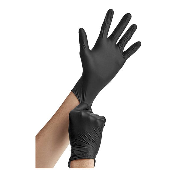 A person wearing Noble Products black nitrile gloves.