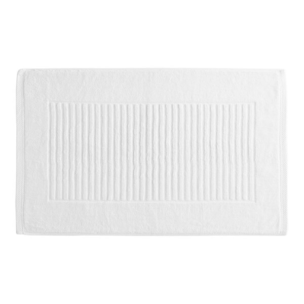 A white Garnier-Thiebaut bath mat with a stripe pattern.