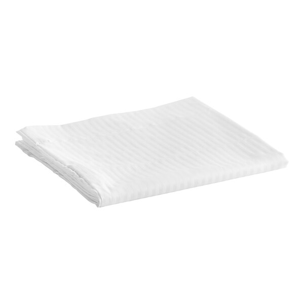 A folded white tone-on-tone stripe Garnier-Thiebaut pillowcase on a white surface.