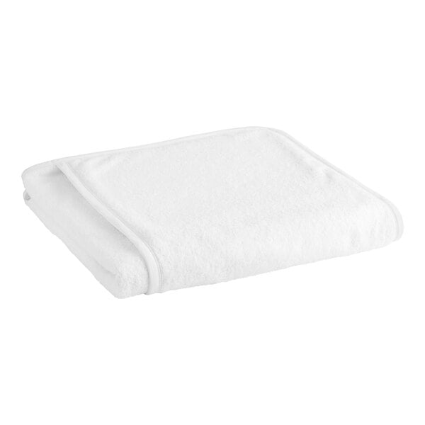 A close-up of a white Garnier-Thiebaut 100% cotton lounge chair cover.