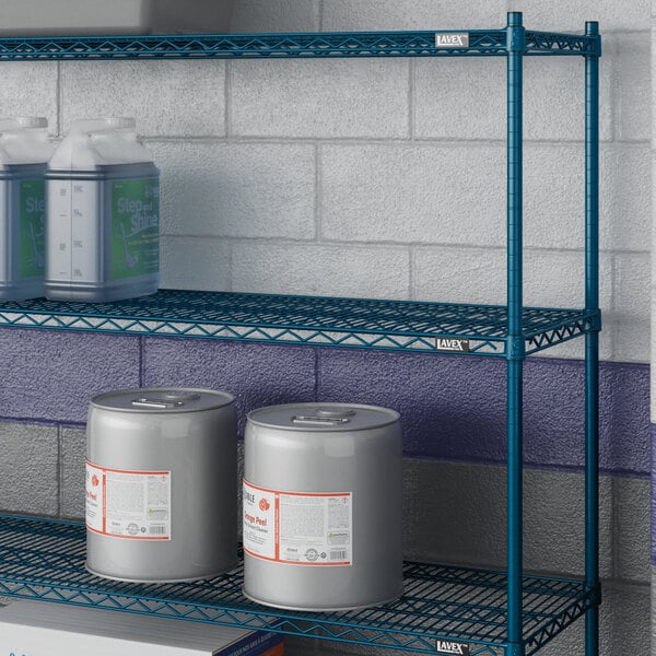 A blue Lavex Pro wire shelf with containers and cans on it.