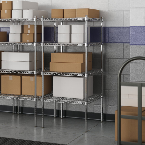 A metal wire shelving unit with boxes on the shelves.