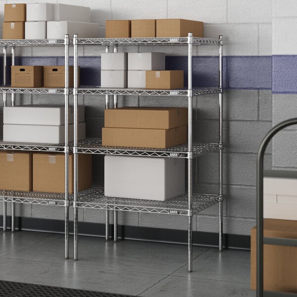 A white rectangular metal shelf unit with four shelves holding boxes.