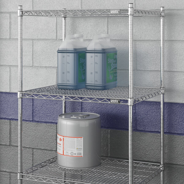 A Lavex Pro metal wire shelf with containers and a canister on it.