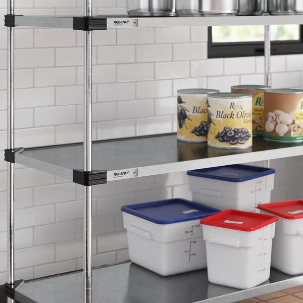 A Regency galvanized steel shelf with white and red containers on it.
