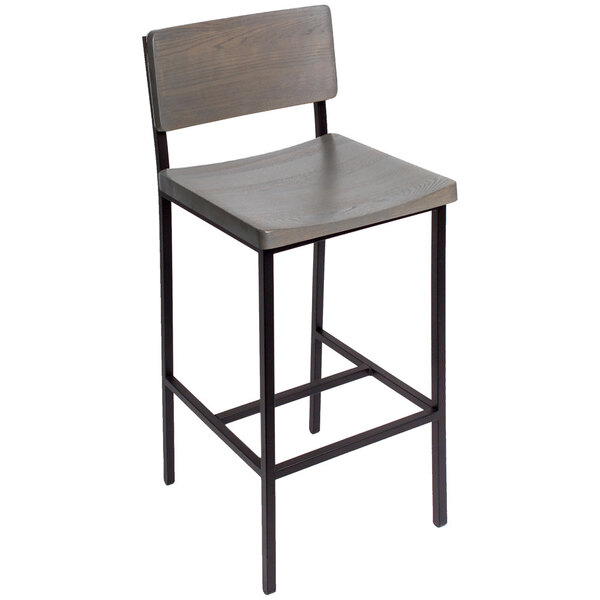 A BFM Seating Memphis bar height chair with a black metal frame and wooden back and seat.