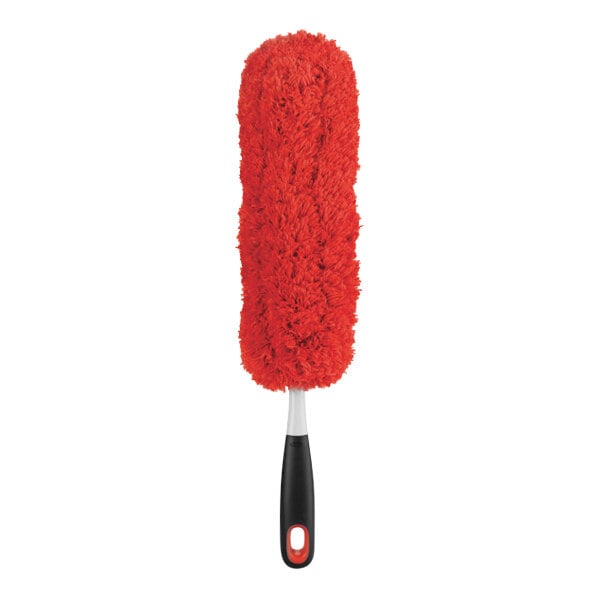 An OXO Good Grips red fluffy duster with a black handle.