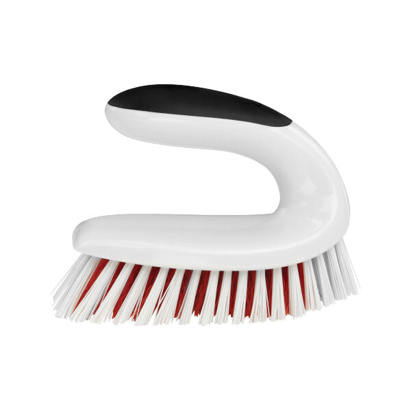 A white and black OXO Good Grips scrub brush with red bristles.