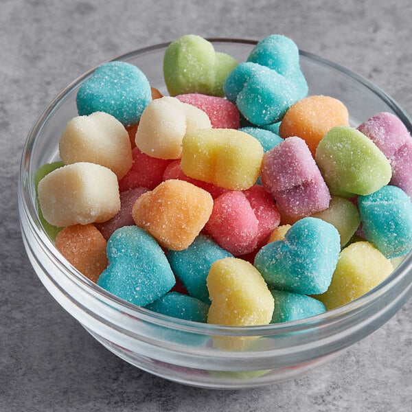 A white bowl filled with Albanese sanded gummi candy hearts.