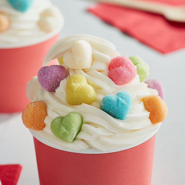 A cup of ice cream with Albanese sanded gummi hearts on top.