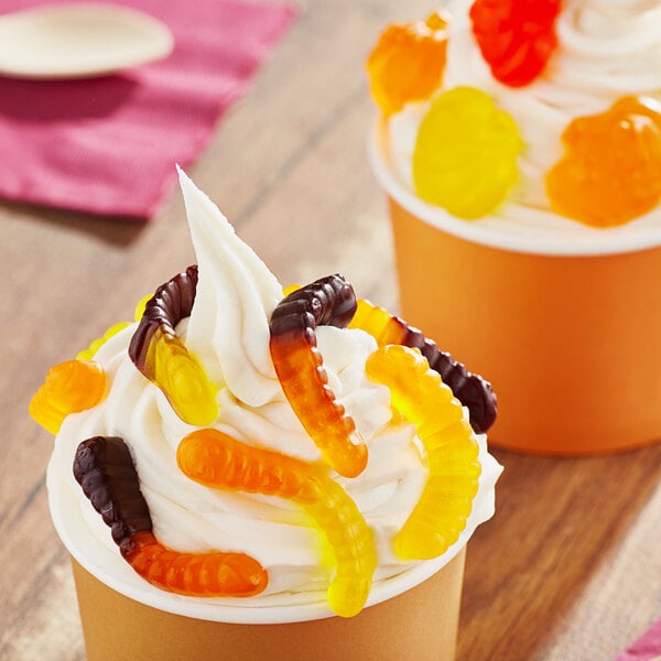 A cup of ice cream topped with Albanese Fall Mini Gummi Worms.