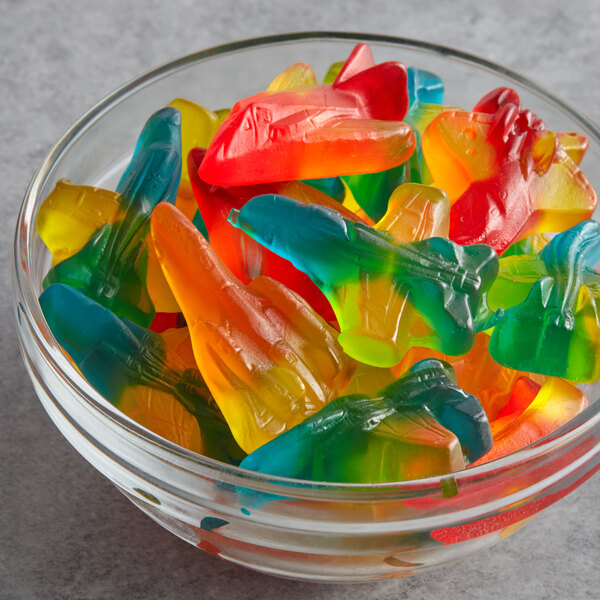 A bowl filled with colorful Albanese Gummi Jet Fighters.
