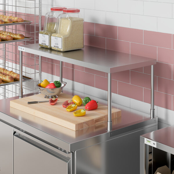 An Avantco stainless steel single deck overshelf on a counter in a kitchen.