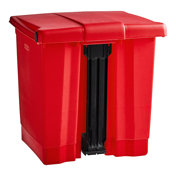 A red Rubbermaid plastic rectangular step-on trash can with a black lid.