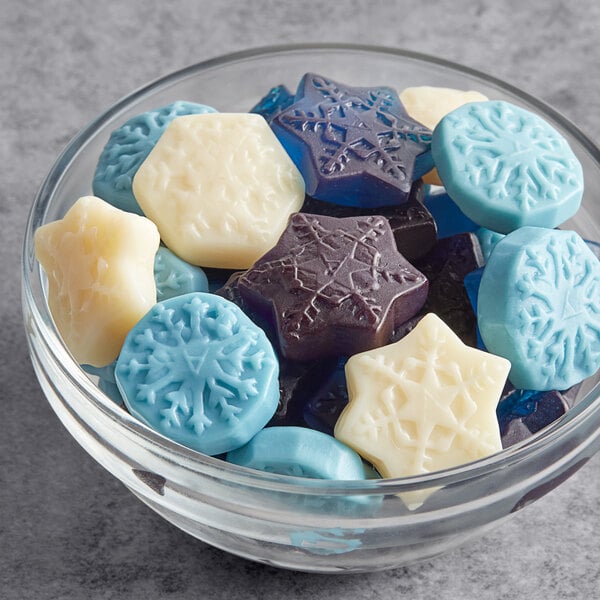 A bowl of white star-shaped Albanese Gummi Snowflakes.