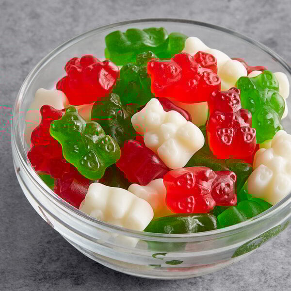 A bowl of Albanese Christmas Gummi Bears with red, green, and white candies.