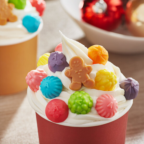 A cupcake decorated with Jolly Gingerbread Gummi candy on top.