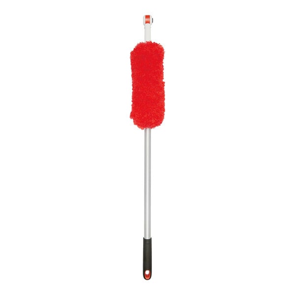 A long-handled dusting tool with a red microfiber head and a black grip handle.