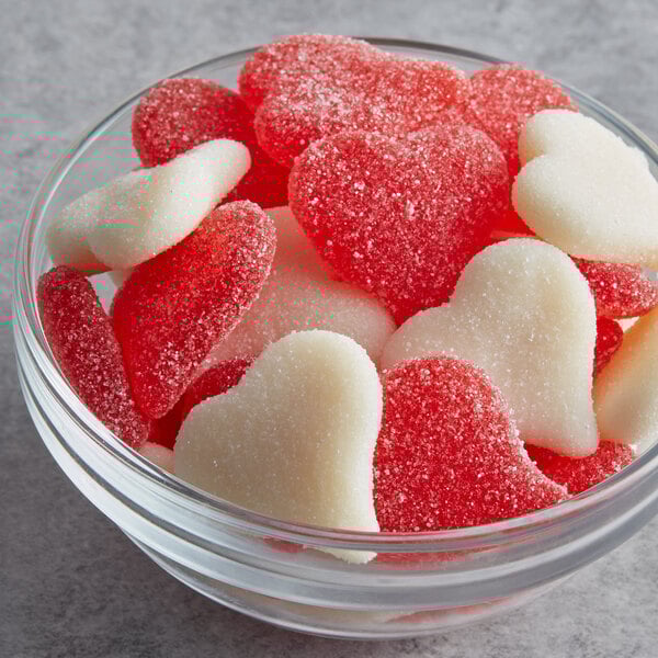 A bowl of Albanese red and white heart shaped sour gummi candy.