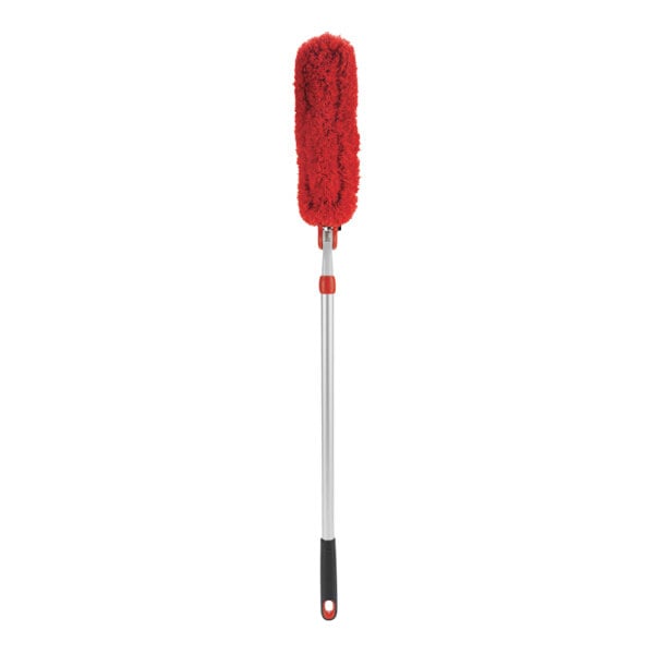 An OXO red duster with a black handle.