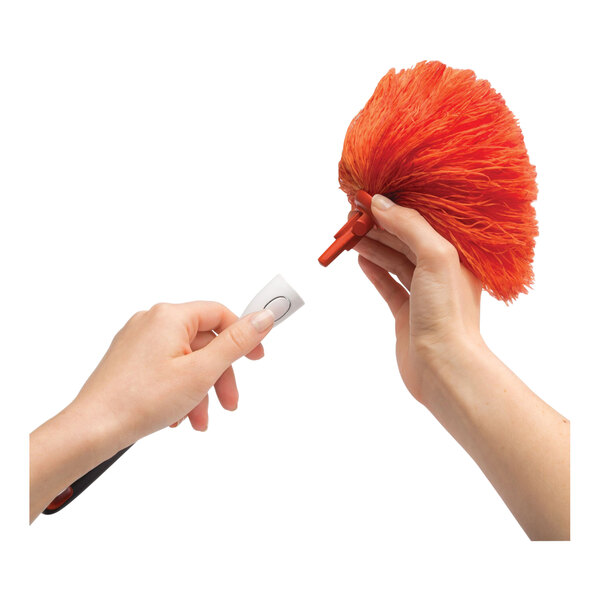 A replacement microfiber duster head being attached to a handle.