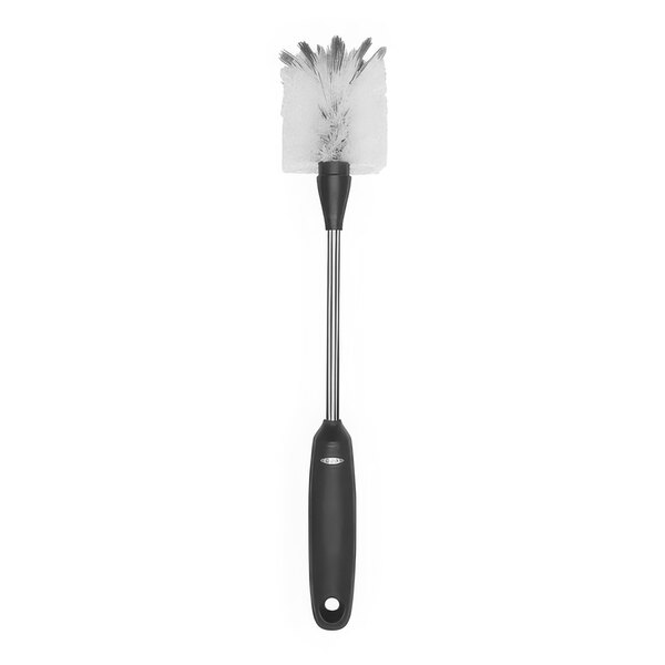 An OXO SteeL stainless steel bottle cleaning brush with a black handle.