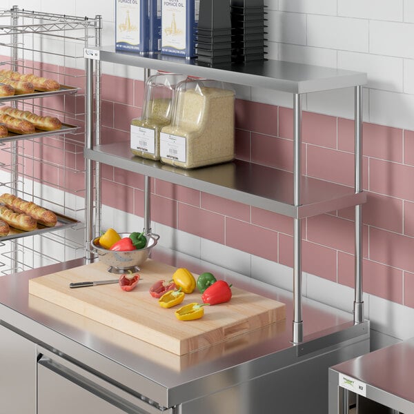 An Avantco stainless steel double deck overshelf on a counter in a kitchen.