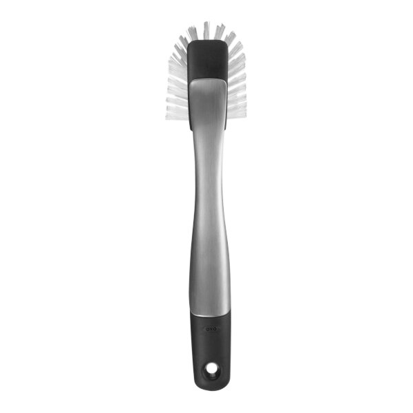 An OXO SteeL stainless steel dish brush with a black and silver handle.