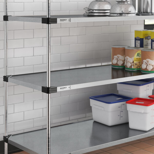 A Regency galvanized steel shelf with food and containers on it.