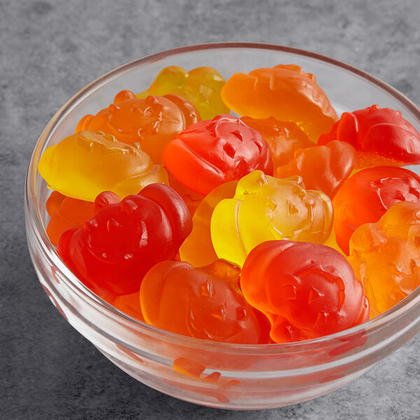 A bowl of Albanese Fall Gummi Pumpkins on a table.