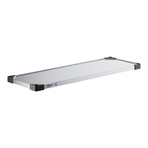 A white rectangular object with a silver border, Regency galvanized steel wall shelf.