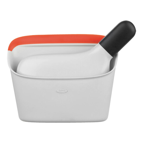 A white and orange pan with a black handle.