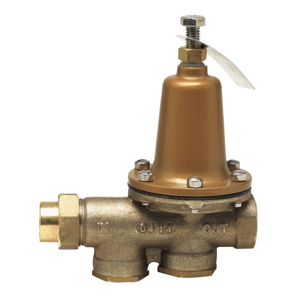 A brass Watts water pressure reducing valve with gold accents.