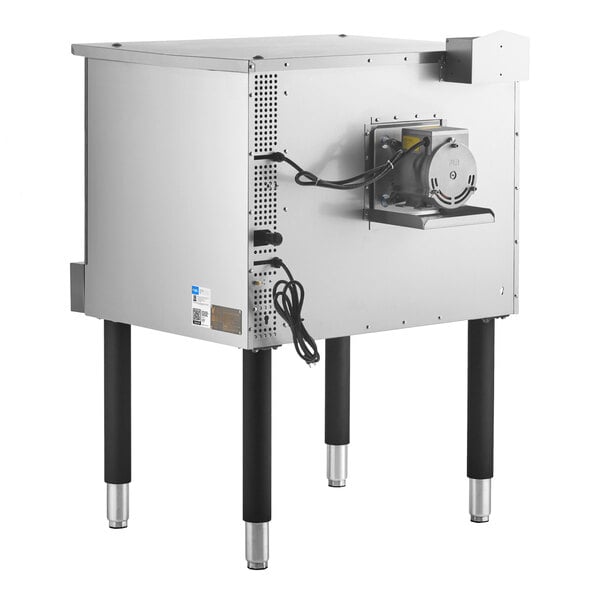 A stainless steel commercial oven with four black legs, a visible power cord, and a motor mounted on the back panel.