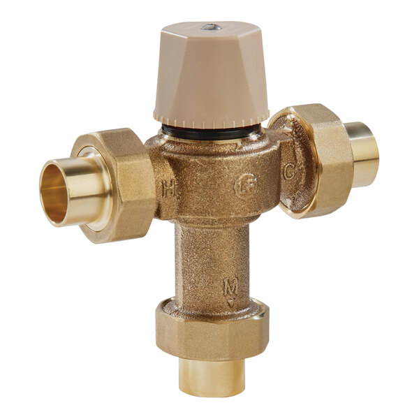 A close-up of a Watts brass thermostatic mixing valve with two brass pipes.